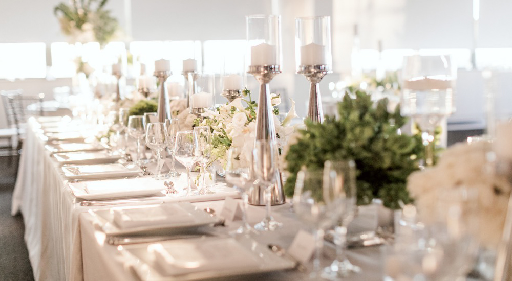 Special event table featuring sage green centerpieces