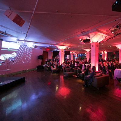 photo: people watching multimedia presentation in tr360 with pink uplighting