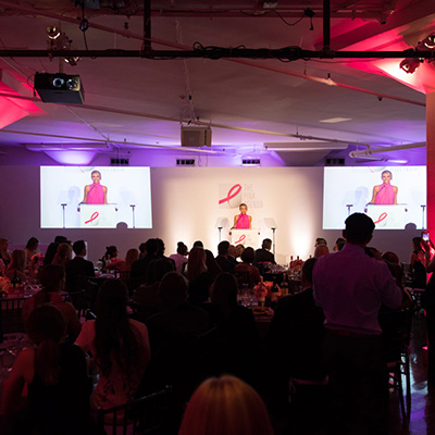 photo: guests watching presenter on stage at Pink Agenda Event