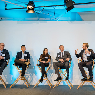 photo: 5 person panel on stage at a corporate event at tr360