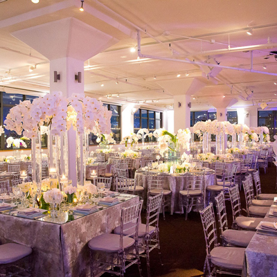 photo: wedding reception decor with large white floral centerpieces