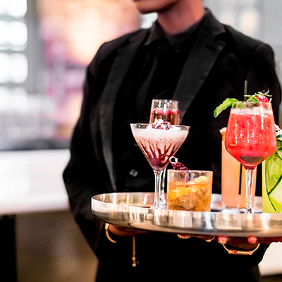 photo: waiter carrying tray of colorful beverages