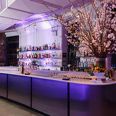 photo: main bar with glassware and floral arrangements