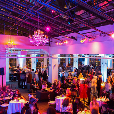 photo: seated corporate dinner with pink uplighting