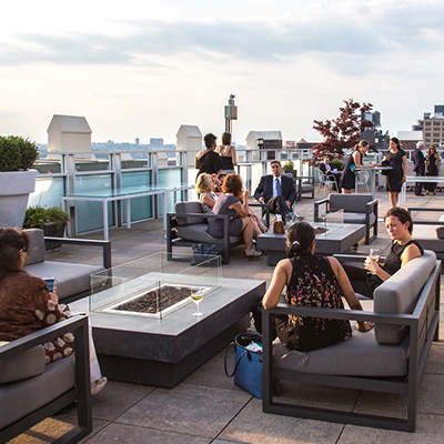 photo: rooftop corporate event people sitting on lounge furniture