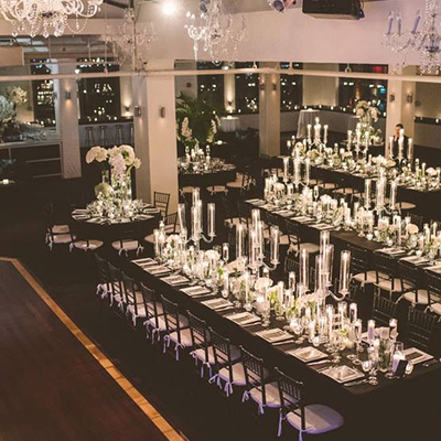 photo: wedding at tribecarooftop with long tables and glass centerpieces