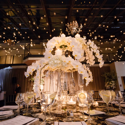photo: closeup of table decor with lights floating above the dancefloor