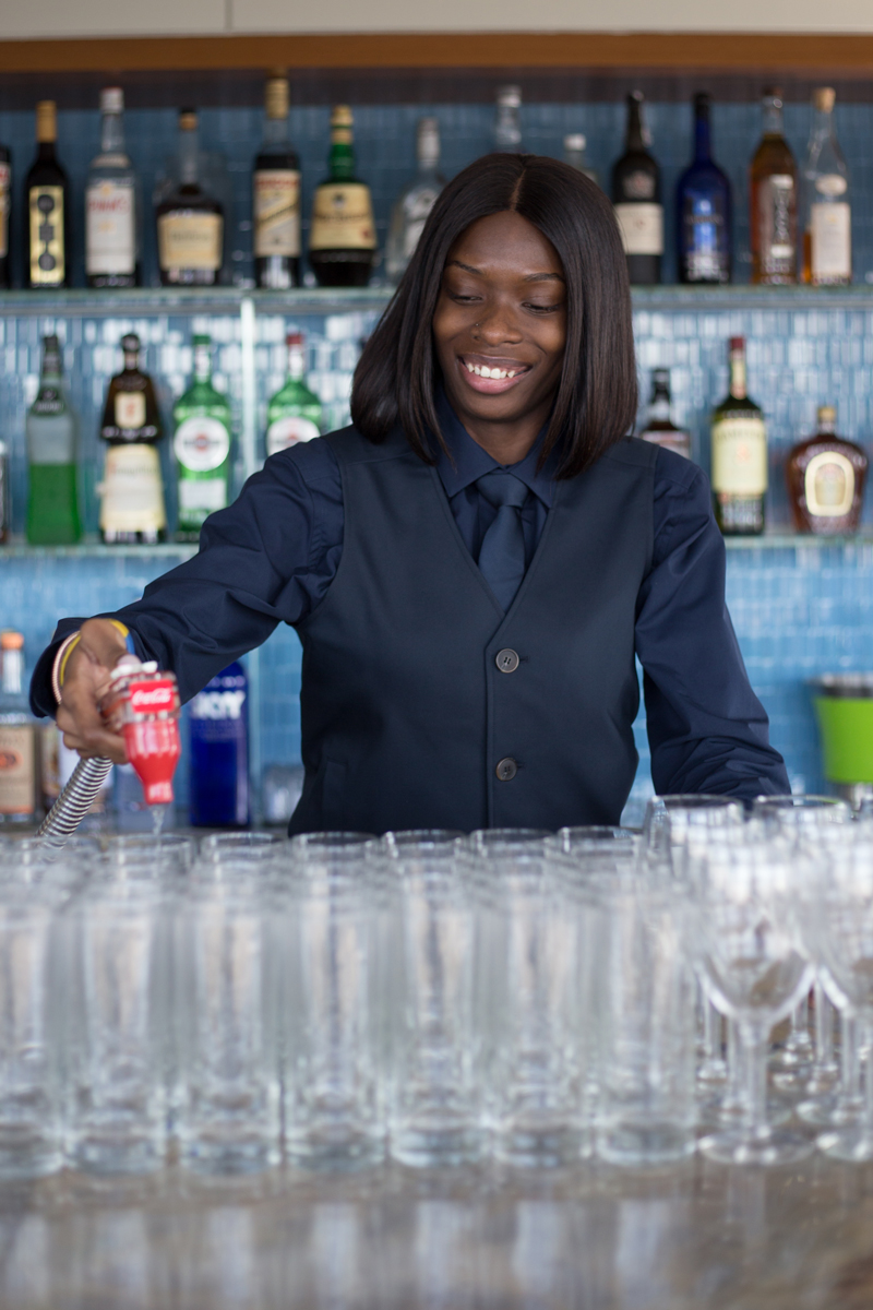 photo: female waiter pouring drinks at event